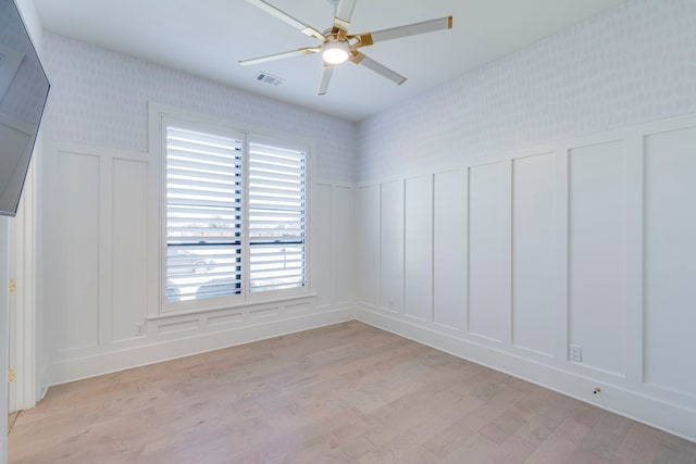 spare room with ceiling fan and light hardwood / wood-style flooring