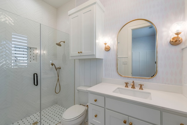 bathroom featuring vanity, an enclosed shower, and toilet