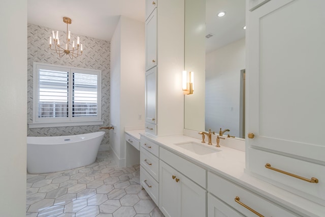 bathroom featuring tile patterned flooring, a bathing tub, vanity, and a chandelier