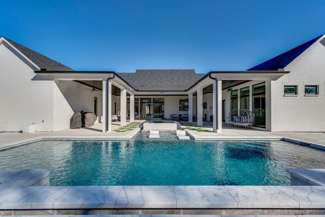 view of swimming pool with an in ground hot tub, ceiling fan, and a patio