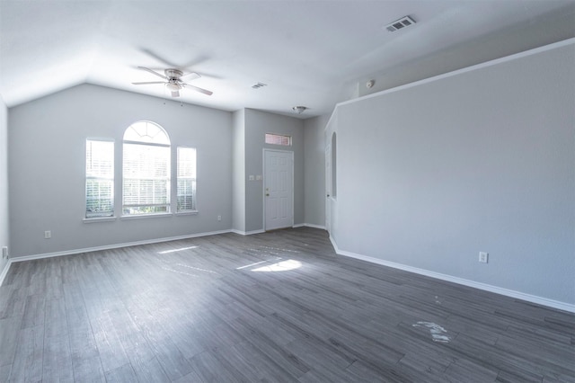 empty room with lofted ceiling, dark hardwood / wood-style floors, and ceiling fan