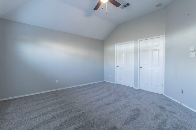 unfurnished bedroom featuring ceiling fan, lofted ceiling, and carpet floors