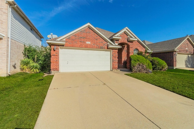 view of front of property featuring a garage and a front lawn