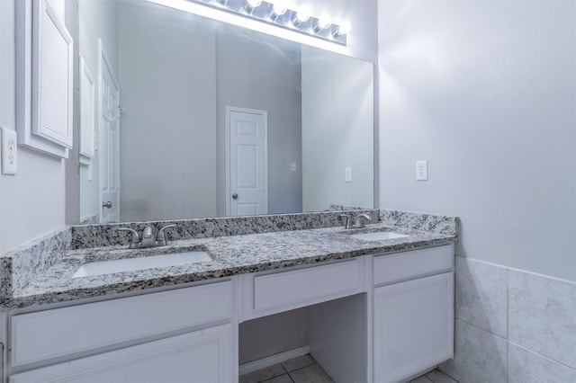 bathroom with tile patterned flooring, vanity, and tile walls