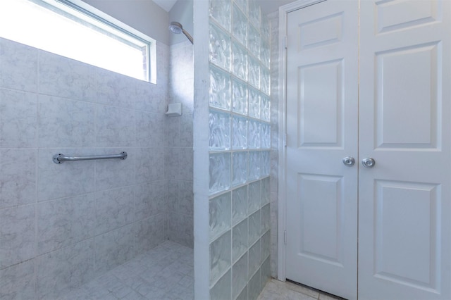 bathroom with a tile shower