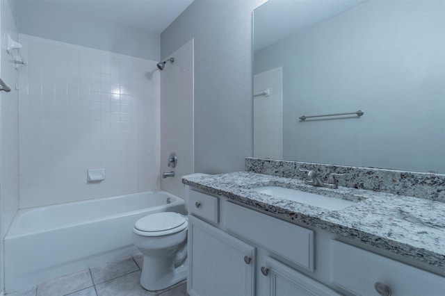 full bathroom with tile patterned flooring, vanity, tiled shower / bath combo, and toilet