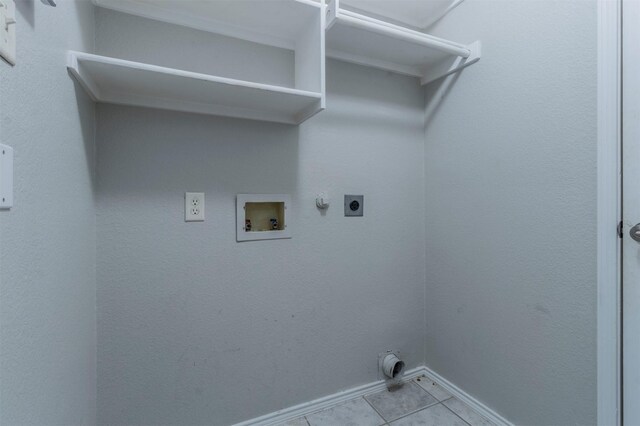 laundry room with gas dryer hookup, hookup for an electric dryer, hookup for a washing machine, and light tile patterned floors