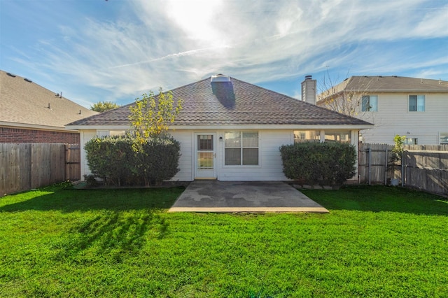 back of house featuring a lawn and a patio