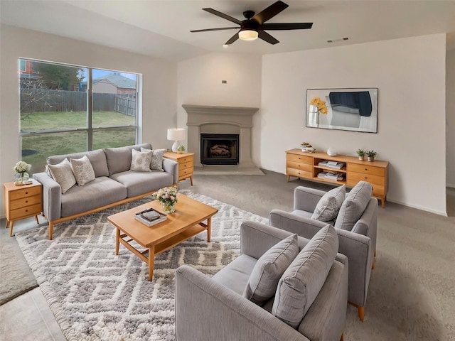 carpeted living room with ceiling fan