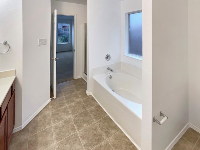 bathroom with tile patterned floors, separate shower and tub, and vanity