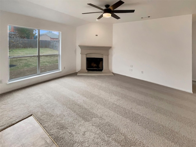 unfurnished living room featuring carpet, ceiling fan, and lofted ceiling