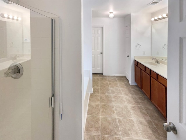 bathroom featuring tile patterned flooring, vanity, and a shower with shower door