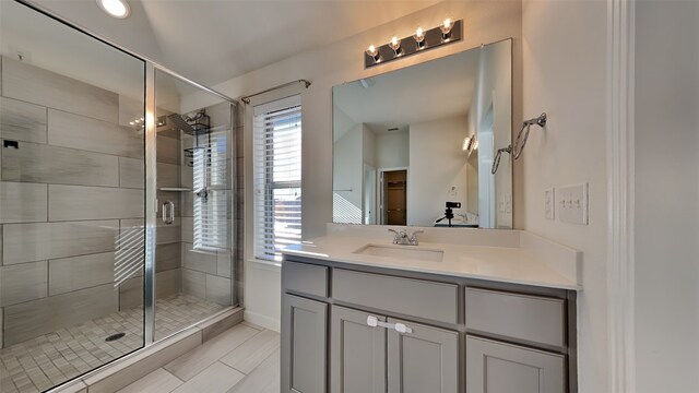 bathroom featuring vanity and a shower with shower door