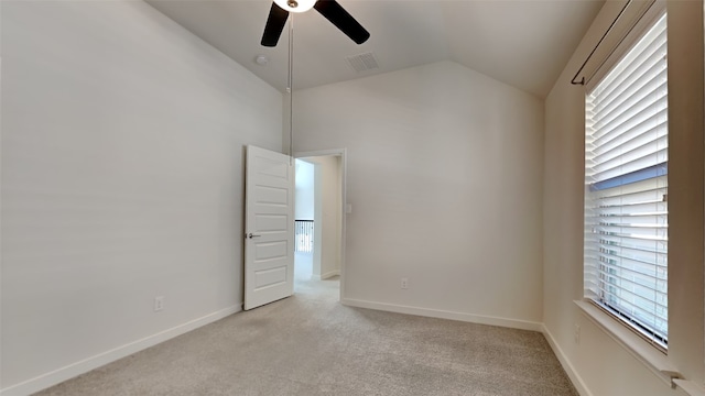 carpeted spare room with lofted ceiling and ceiling fan