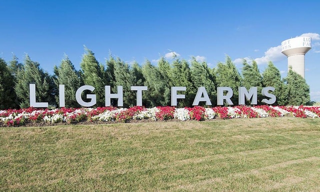 community sign featuring a lawn