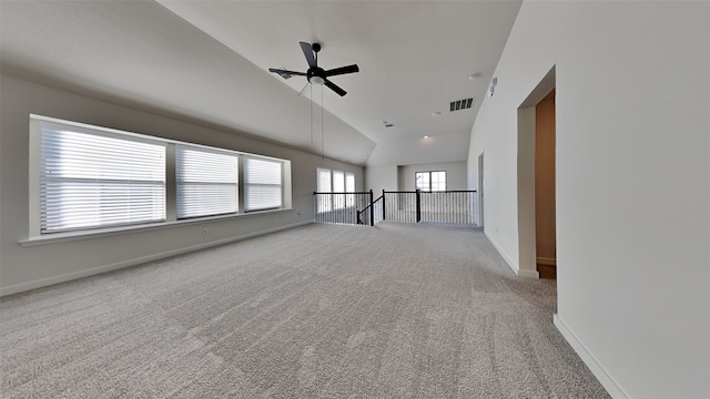 carpeted spare room with high vaulted ceiling and ceiling fan