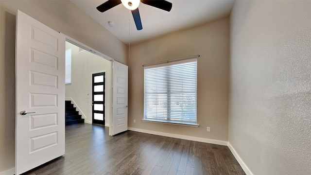 spare room featuring dark hardwood / wood-style flooring and ceiling fan