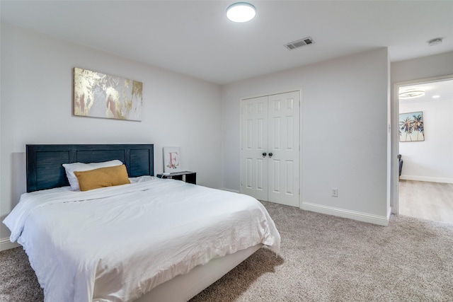 carpeted bedroom featuring a closet