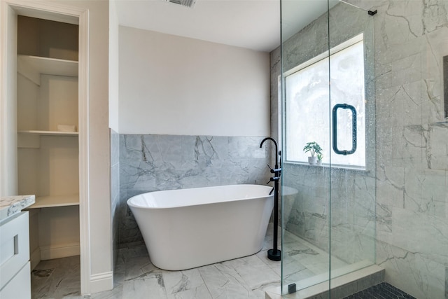 bathroom featuring vanity, separate shower and tub, built in features, and tile walls