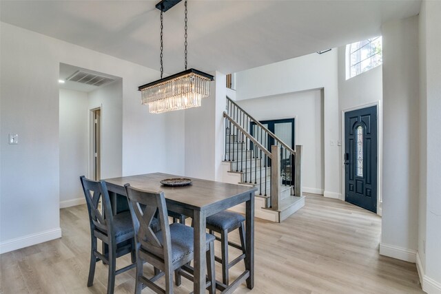 dining room featuring light hardwood / wood-style floors and an inviting chandelier