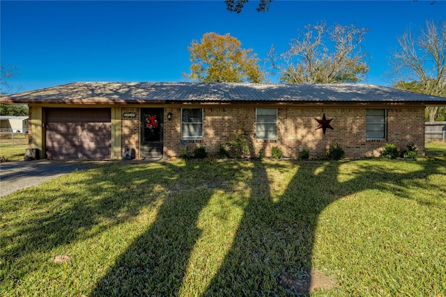 single story home featuring a front yard and a garage