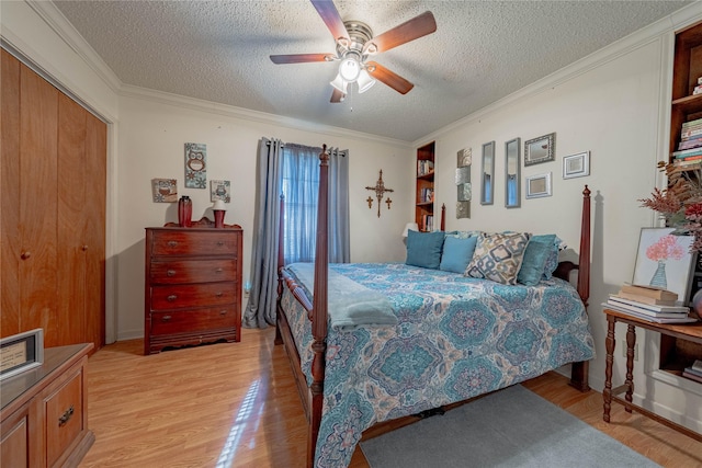 bedroom with a textured ceiling, light wood-type flooring, ceiling fan, and ornamental molding