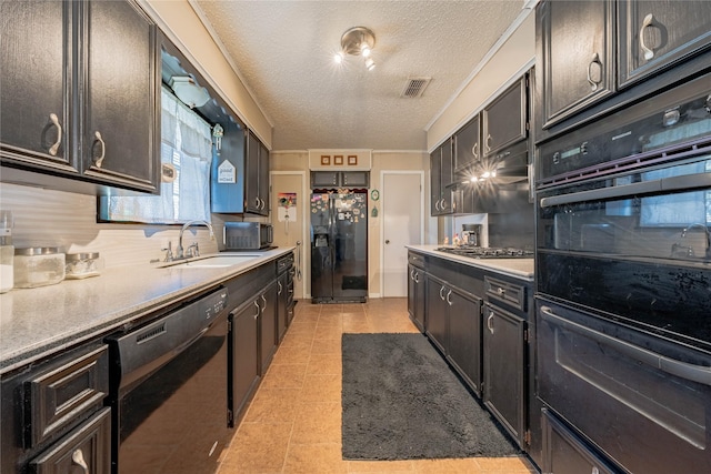 kitchen featuring black appliances, sink, a textured ceiling, tasteful backsplash, and light tile patterned flooring