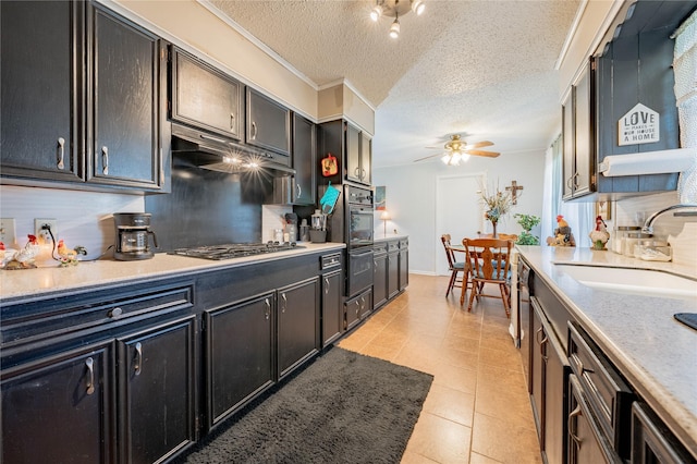 kitchen featuring sink, ceiling fan, light tile patterned floors, a textured ceiling, and stainless steel gas cooktop