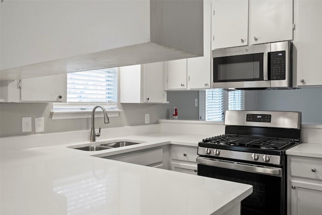 kitchen with white cabinets, appliances with stainless steel finishes, and sink