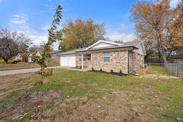 view of front of property with a garage and a front lawn