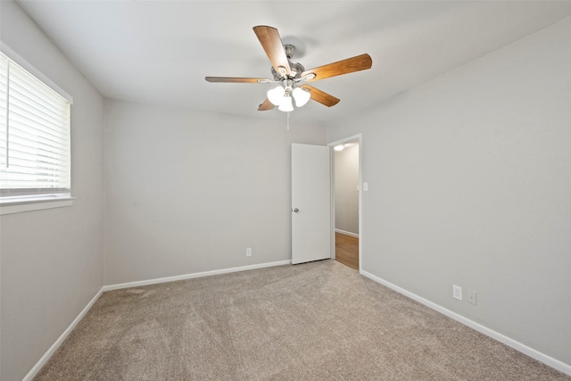 carpeted empty room featuring ceiling fan