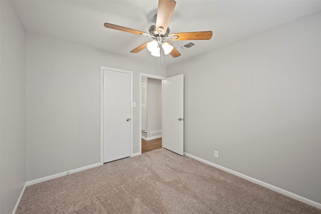 carpeted spare room with ceiling fan