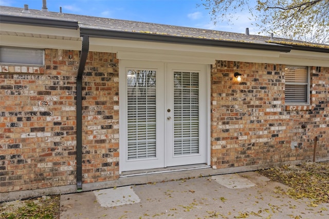 property entrance featuring french doors and a patio area