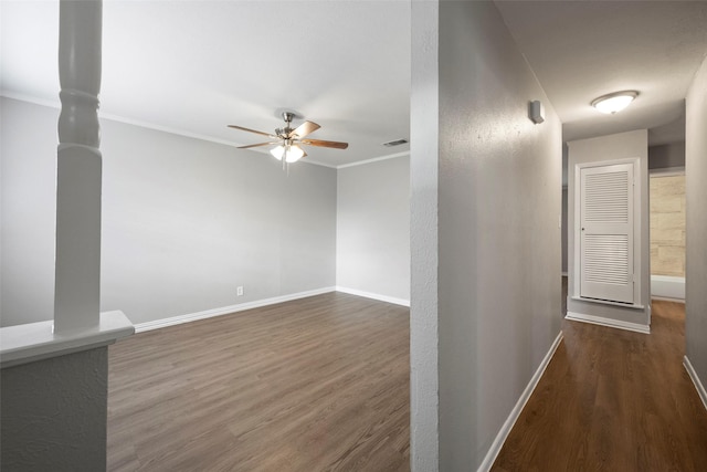 unfurnished living room with dark hardwood / wood-style floors, ceiling fan, and crown molding