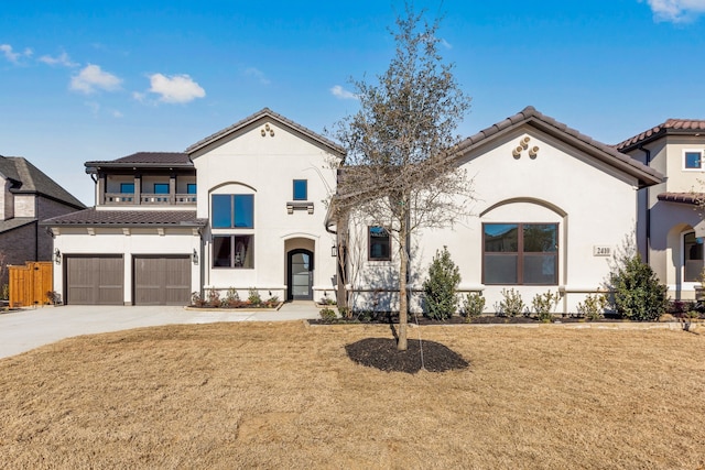 mediterranean / spanish-style home featuring a garage, a balcony, and a front lawn