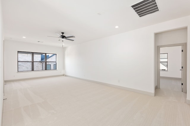 carpeted spare room featuring ceiling fan