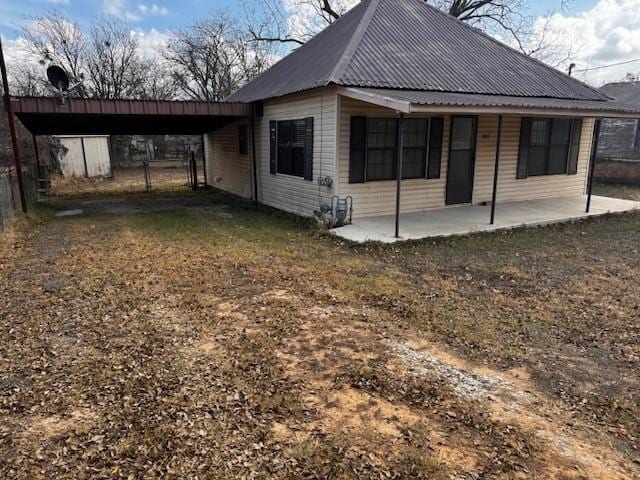 view of property exterior with a yard and a carport