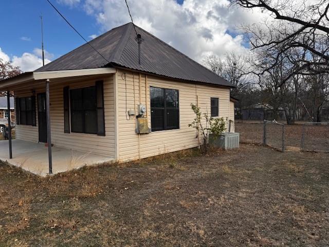 view of property exterior featuring cooling unit and a patio area