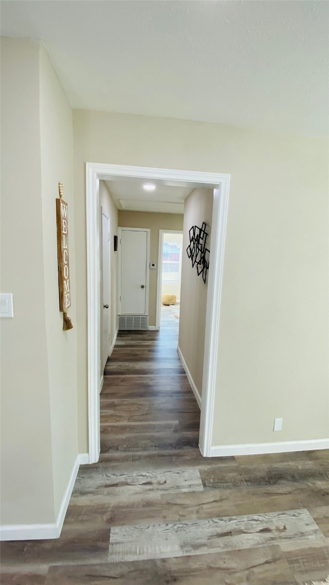 corridor featuring dark wood-type flooring