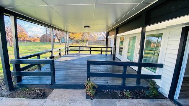 wooden deck featuring a lawn