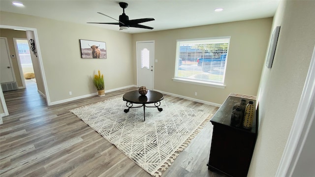 living area featuring ceiling fan and light hardwood / wood-style floors