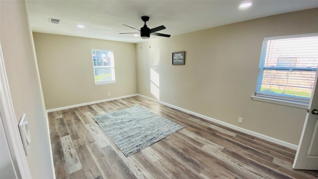 unfurnished room with ceiling fan and hardwood / wood-style floors