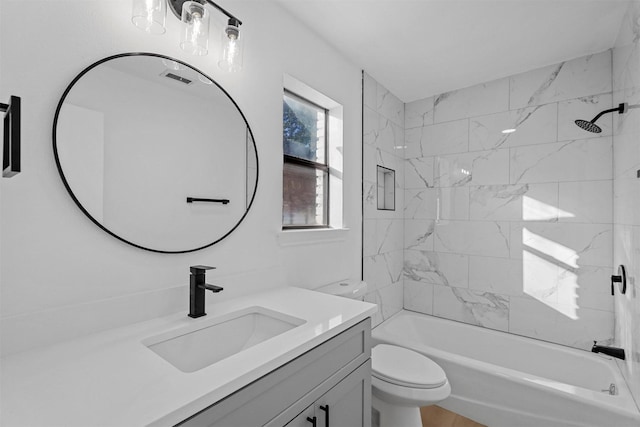 full bathroom featuring vanity, toilet, and tiled shower / bath