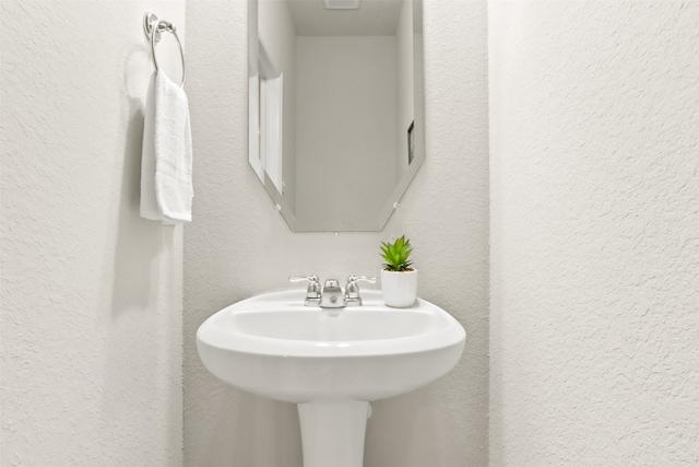 2053 Barx Dr, Little Elm, TX 75068 - bathroom featuring a textured wall and a sink