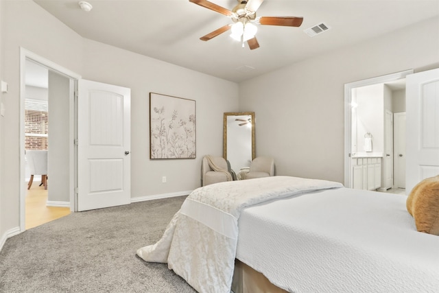 carpeted bedroom featuring ensuite bath and ceiling fan