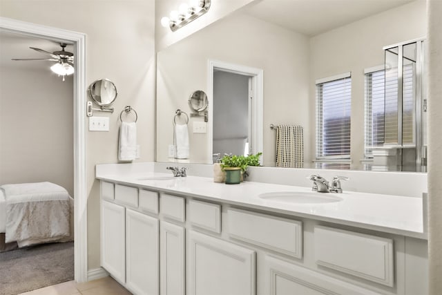 bathroom with tile patterned flooring, vanity, and ceiling fan