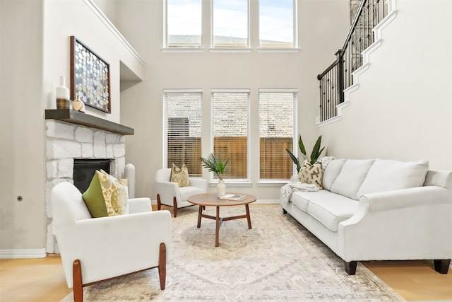 living room with a fireplace and a towering ceiling