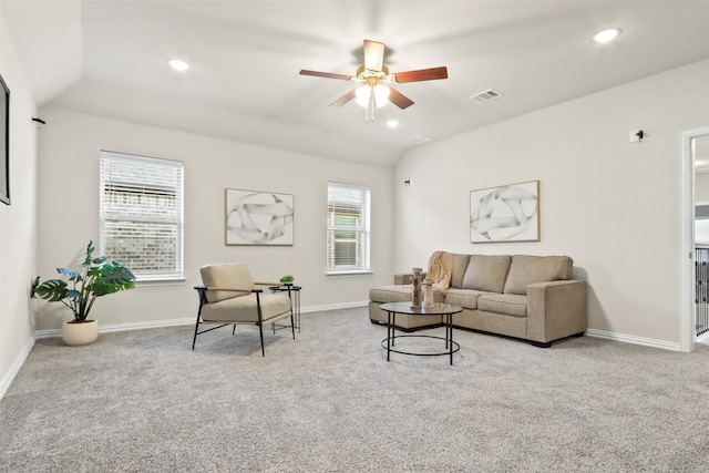 living room with ceiling fan, light colored carpet, a healthy amount of sunlight, and vaulted ceiling