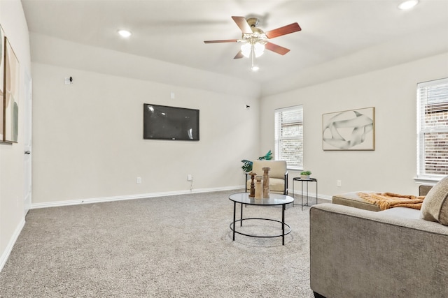 living room with ceiling fan, carpet floors, and a wealth of natural light