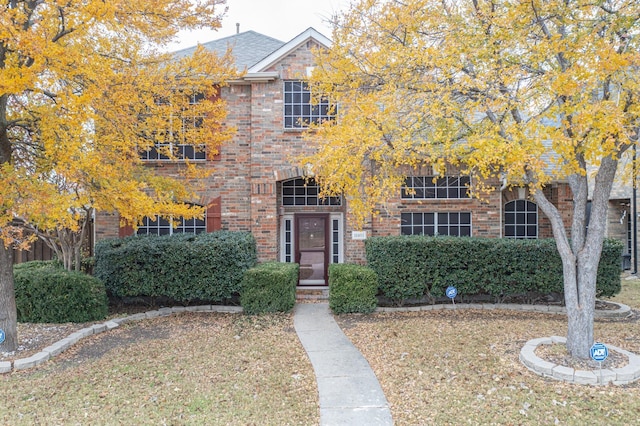 obstructed view of property featuring a front yard